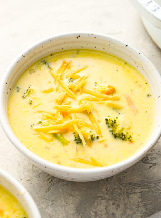 bowls of broccoli cheddar soup topped with cheese