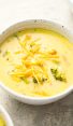 bowls of broccoli cheddar soup topped with cheese