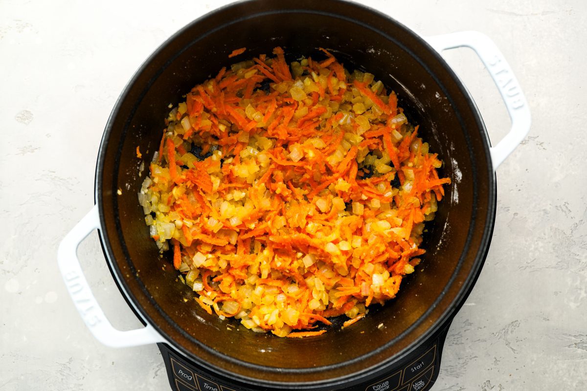 carrots and garlic cooking with onions