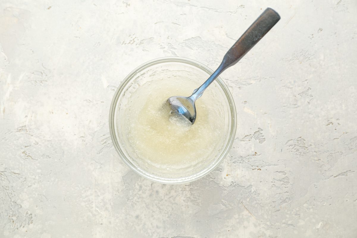 stirring gelatin into water in small glass bowl