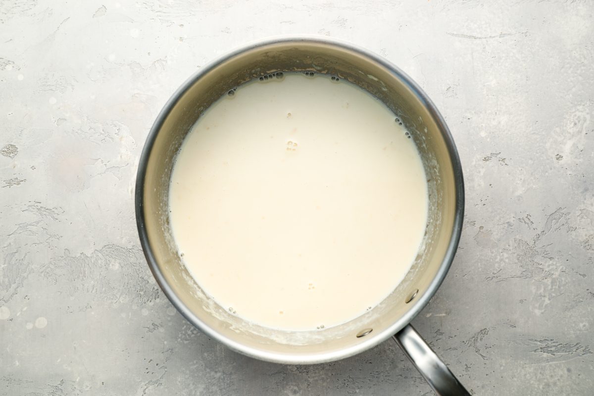 saucepan with bloomed gelatin, vanilla extract, and rum added to milk mixture 