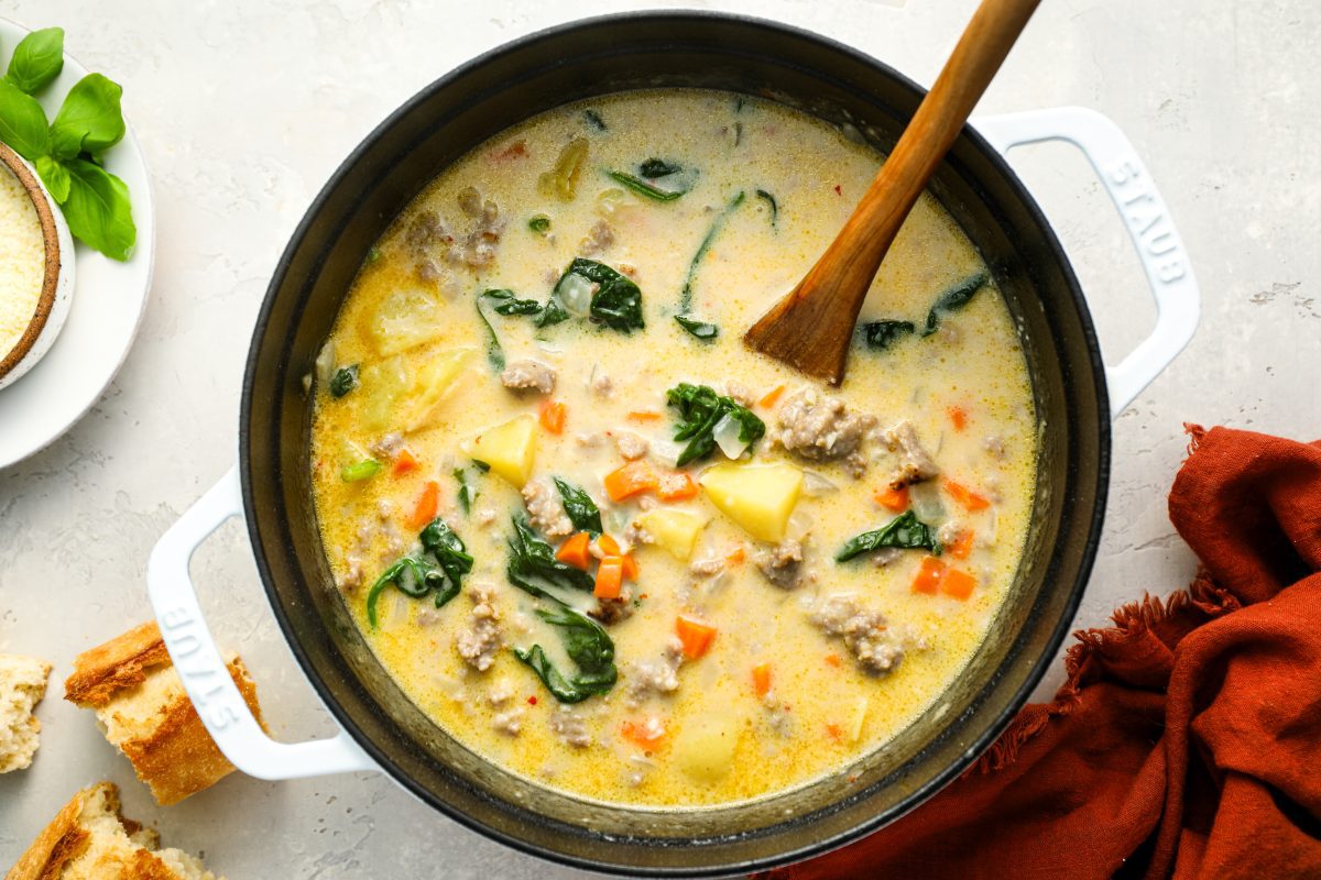 duch oven with zuppa toscana with wooden spoon