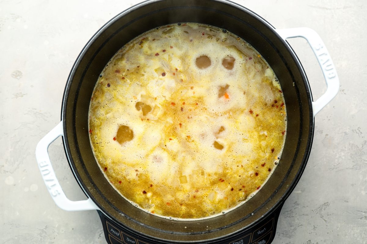 potatoes, salt, black pepper, and crushed red pepper flakes added to dutch oven with chicken broth and vegetable mixture