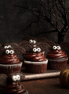 adorable bat cupcakes on cutting board with spooky tree