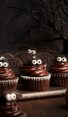 adorable bat cupcakes on cutting board with spooky tree