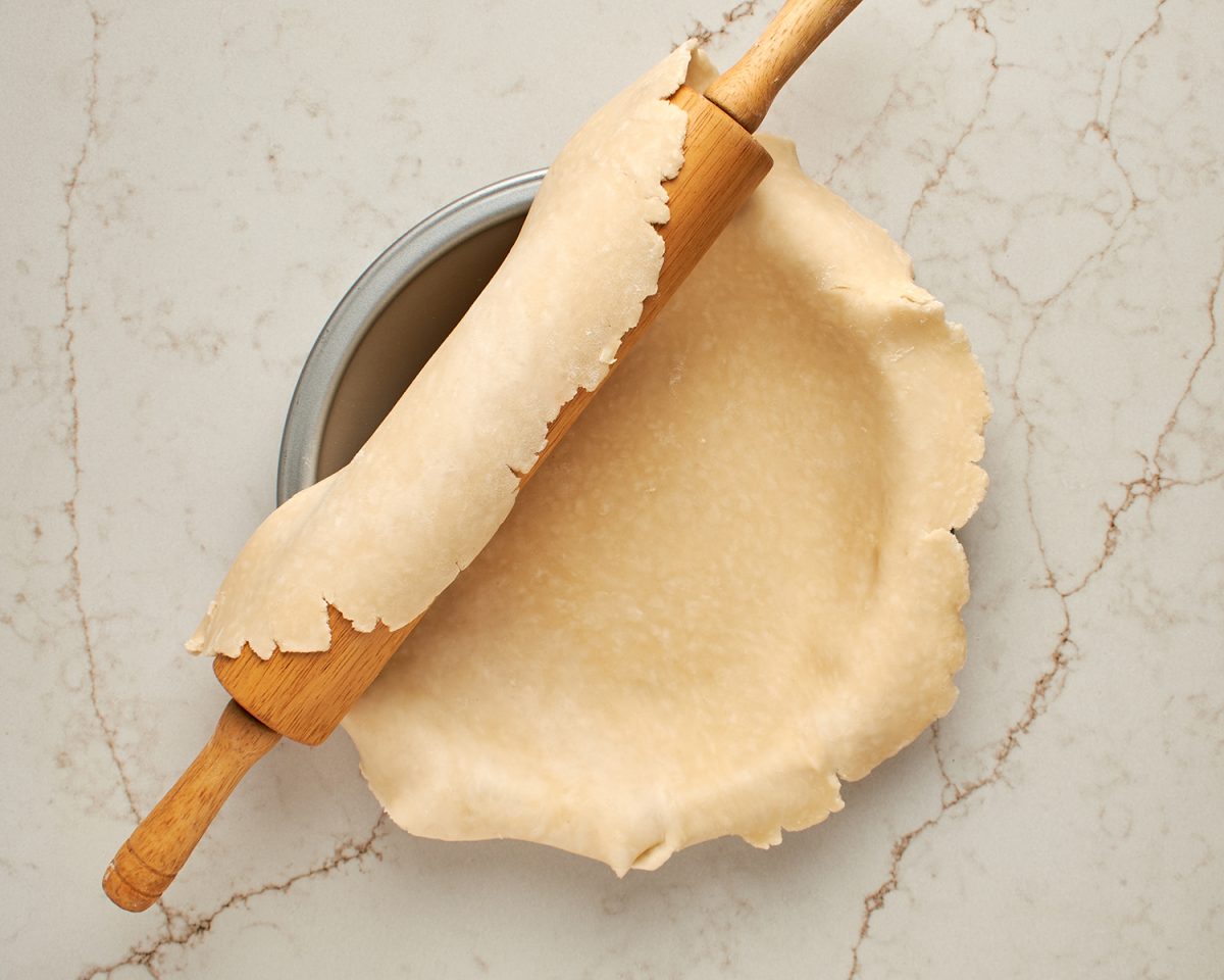 transferring the pie crust to a pie pan