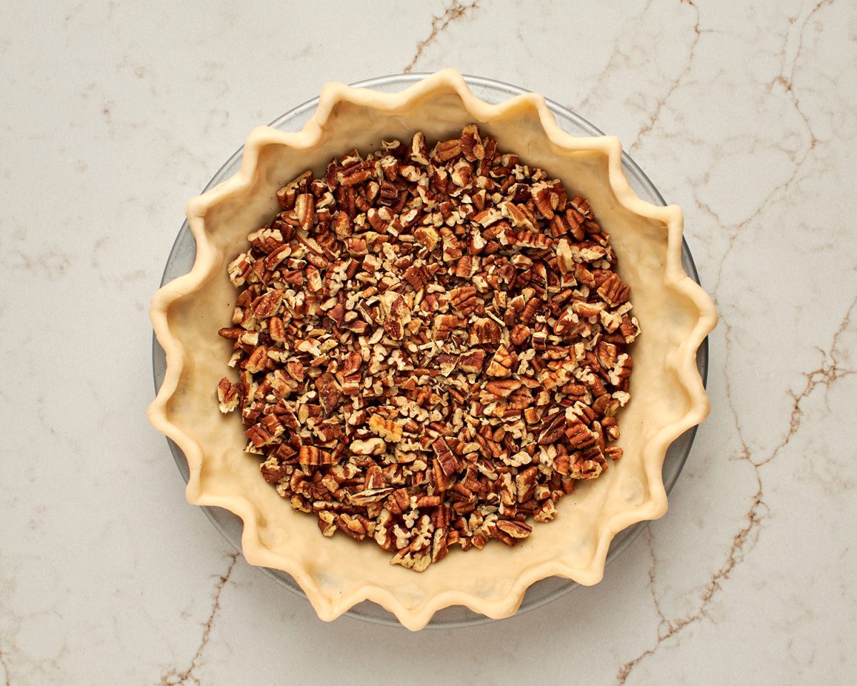 pecans sprinkled in pie crust