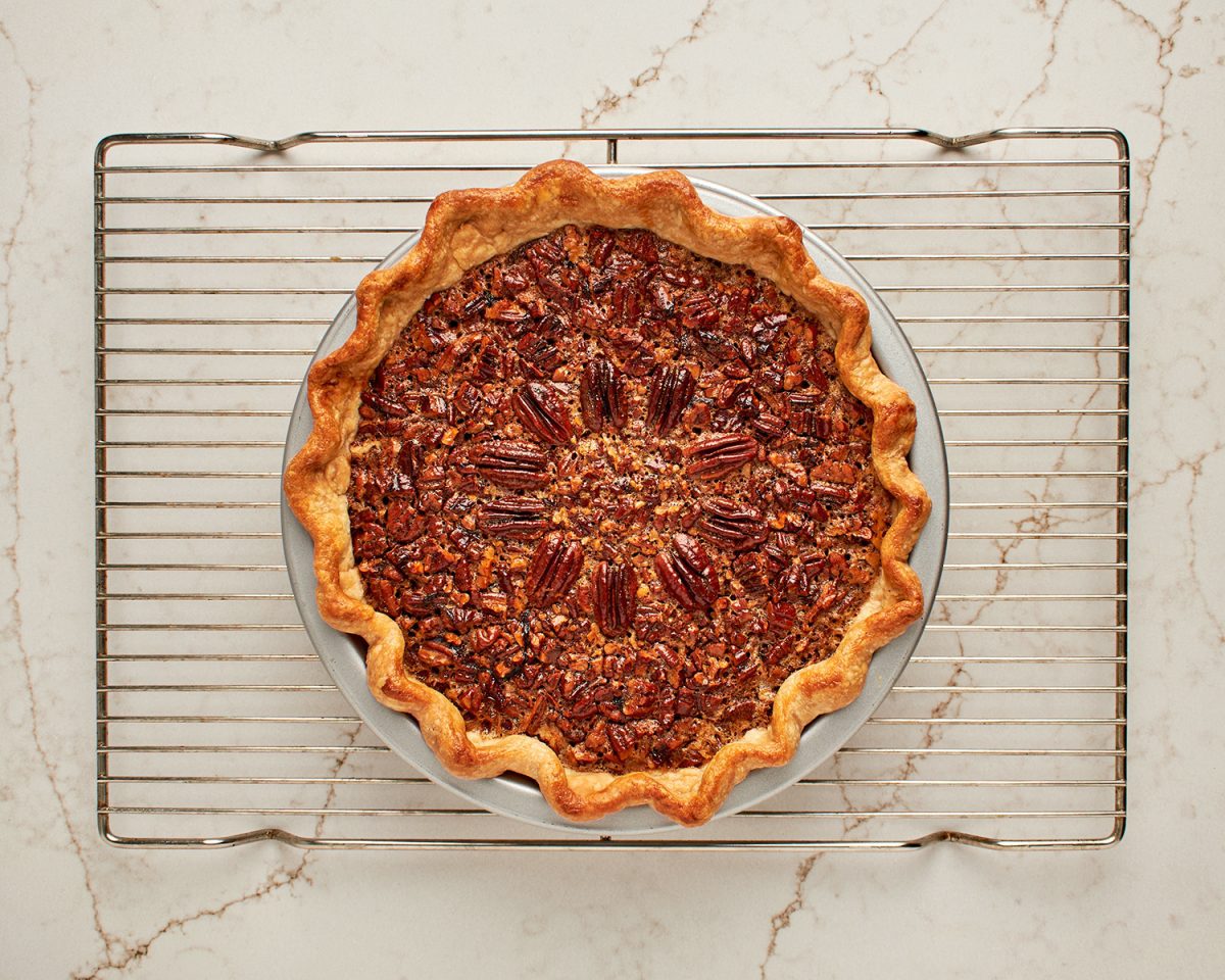 baked bourbon pecan pie cooling on rack