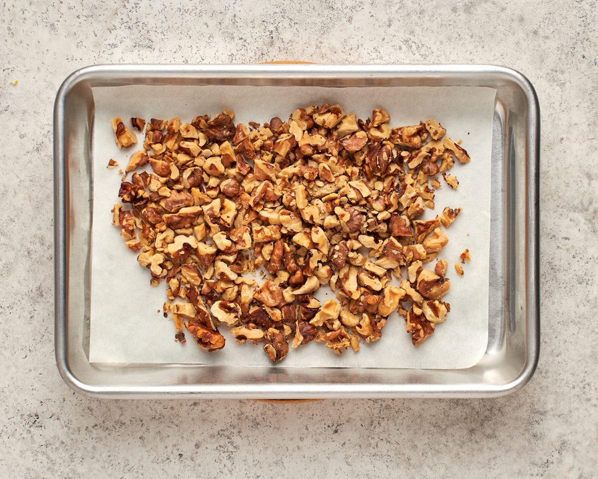 toasted walnuts on parchment lined baking sheet