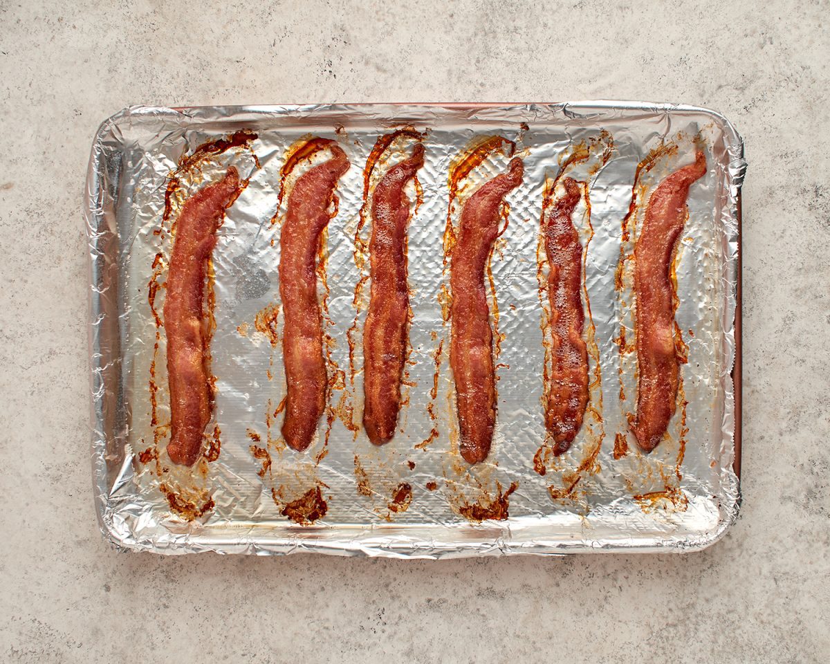 cooked bacon on baking sheet