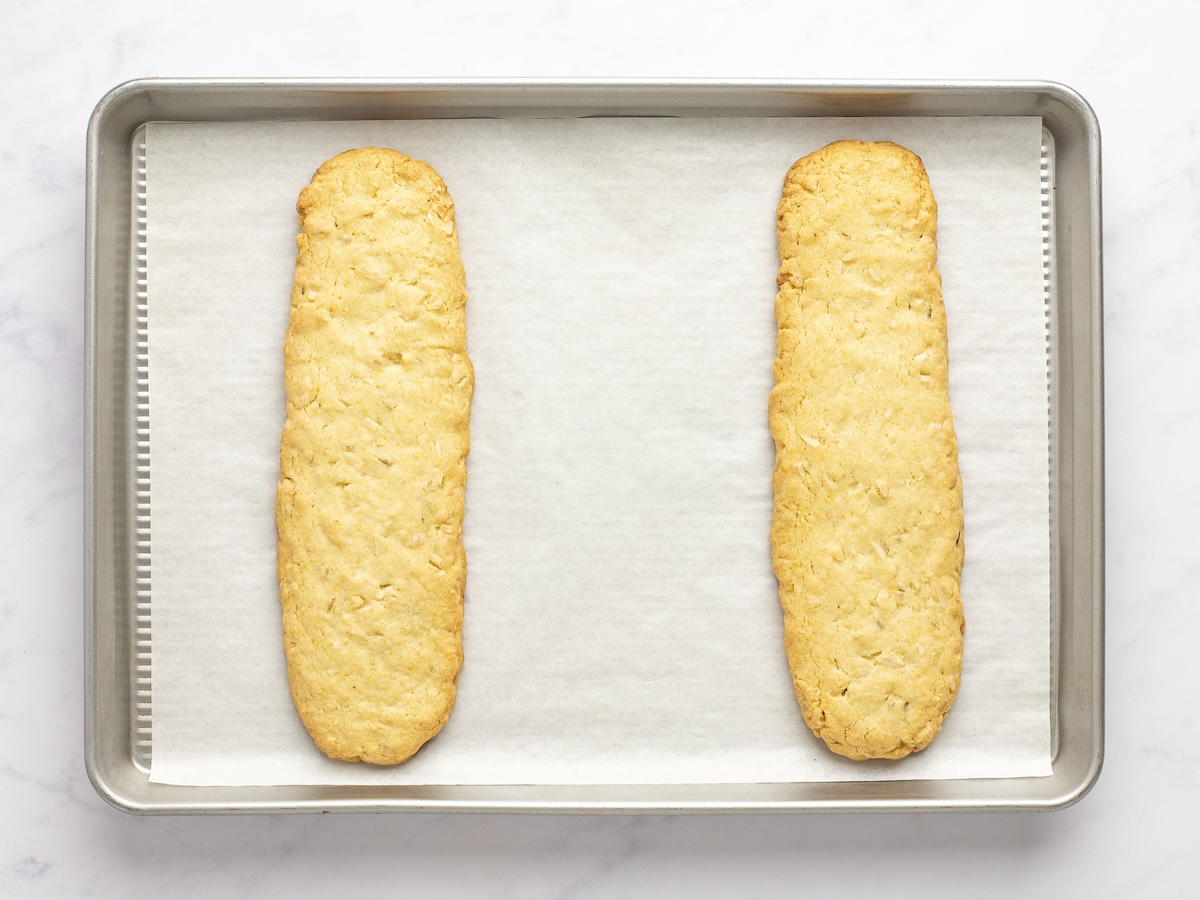 Baked biscotti logs on baking sheet.