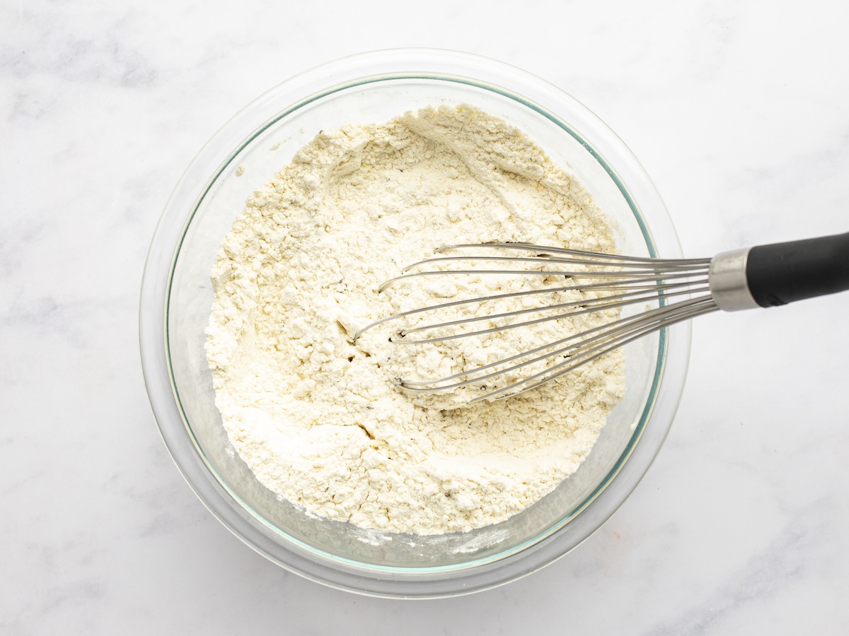 Mixed dry ingredients in bowl with whisk.