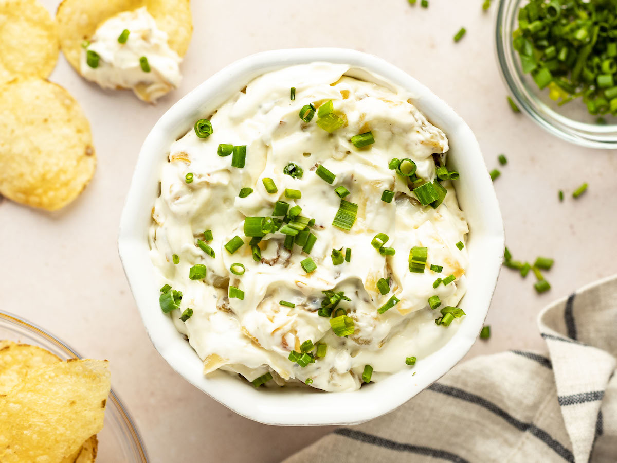 Bowl of French onion dip with potato chips.