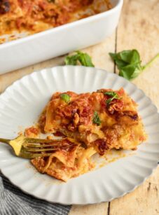 Slice of cheese lasagna on plate.