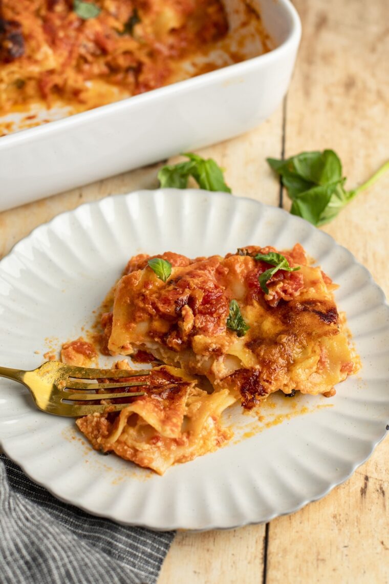 Slice of cheese lasagna on plate.