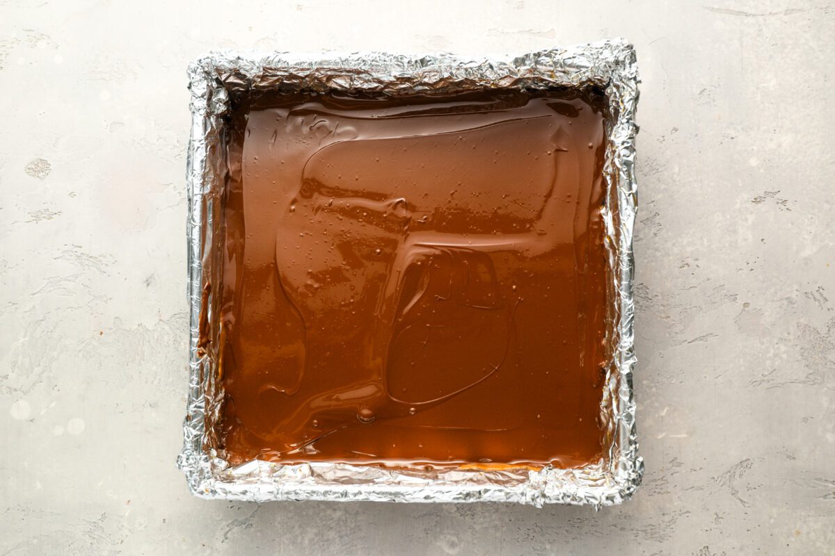 chocolate mixture spread over caramel layer.