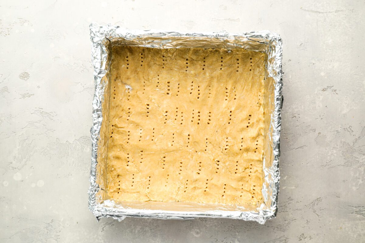 docked millionaire's shortbread crust in foil-lined baking pan.