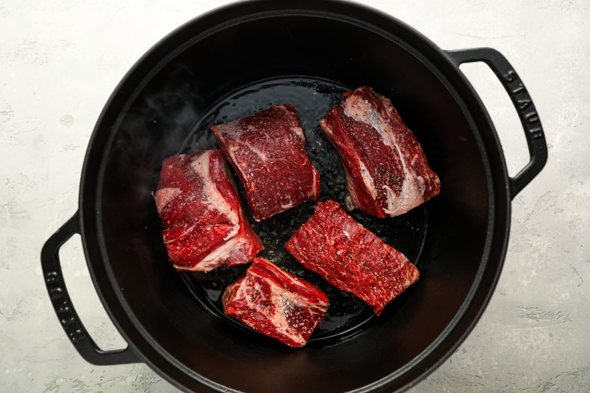 Searing short ribs in Dutch oven.