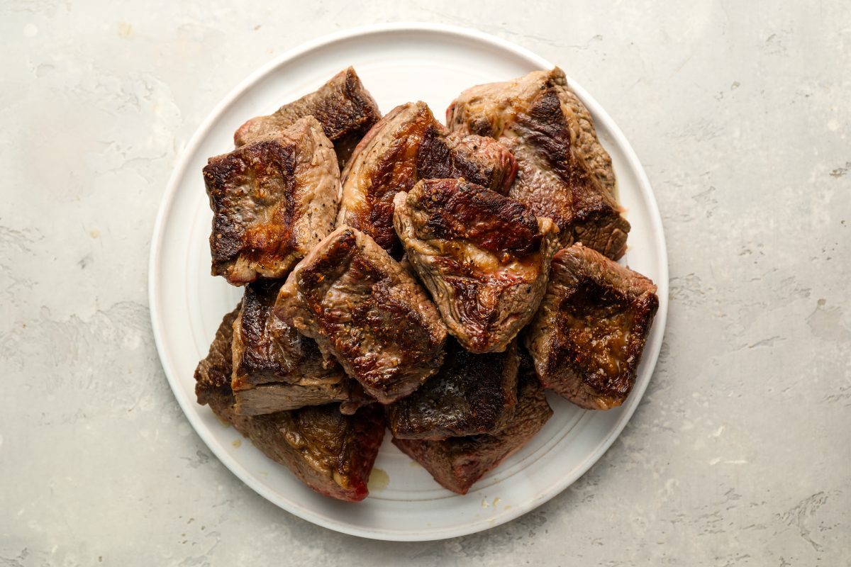 Seared short ribs on plate.